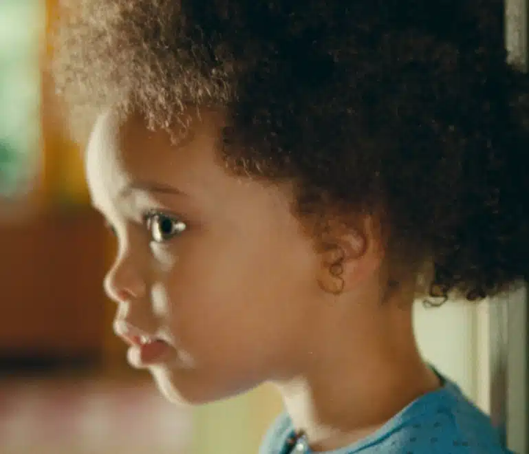 Boy standing against the wall having his height measured
