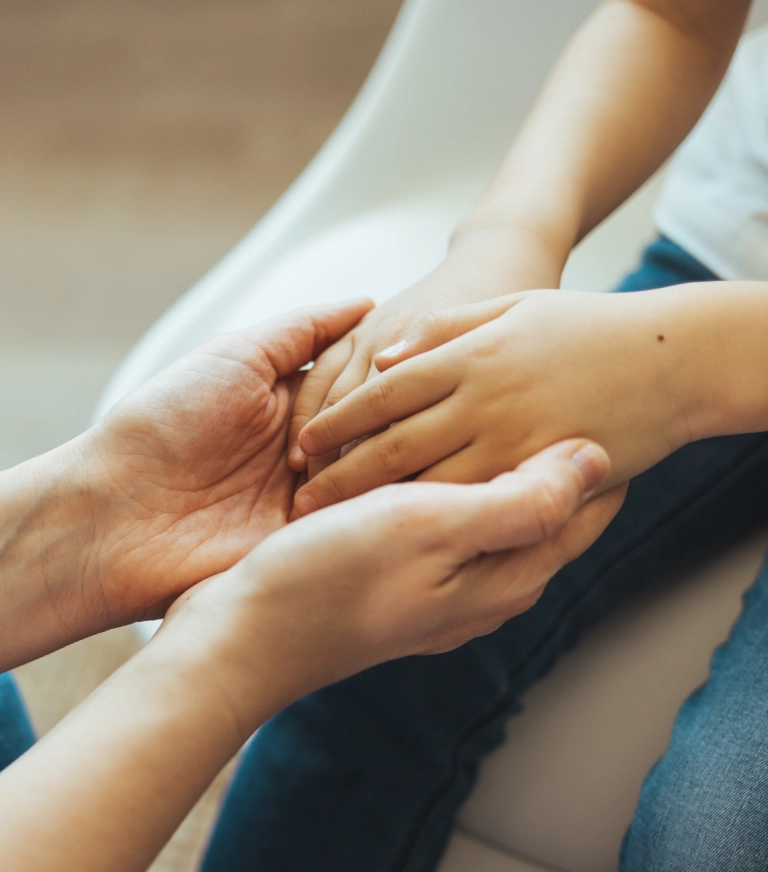 Parent holding hands with child