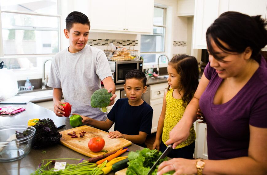 family cooking healthy food together in a kitchen