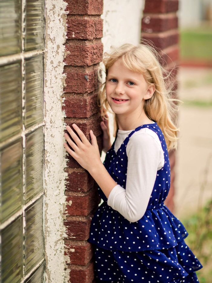 CHOC patient Layla posing outside by a brick wall