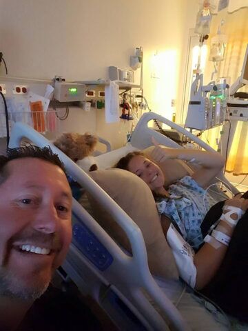 Casey recovers from scoliosis surgery at CHOC Hospital with company from her dad