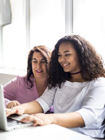 Teen and parent looking at computer