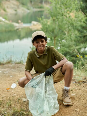 Child picks up garage at lake to help planet. What parents should know about how climate change can impact kids' health.