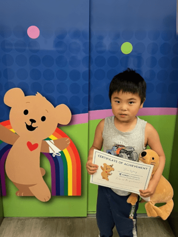 Ein posing with a certificate of achievement