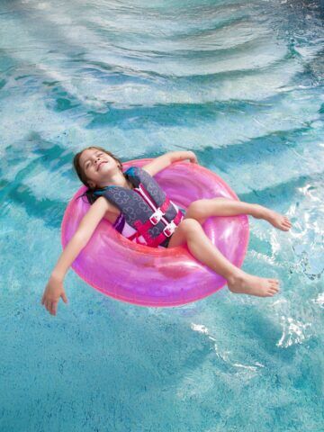 Child enjoying playing in the swimming pool