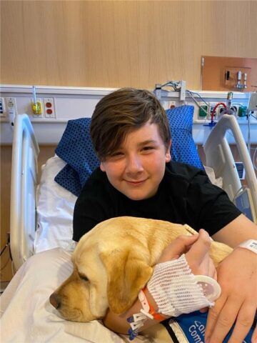 Phillip with CHOC resident service dog