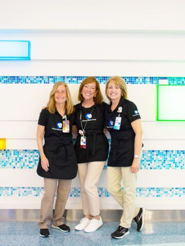 Paula, Kris and Sue smile together at CHOC Hospital in Orange - CHOC volunteers who run a coffee cart