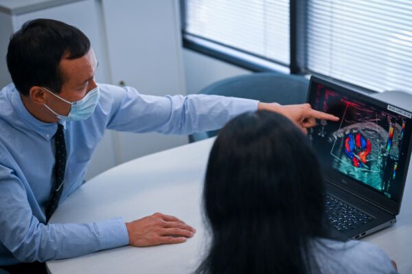 Doctor looks at ultrasound with patient